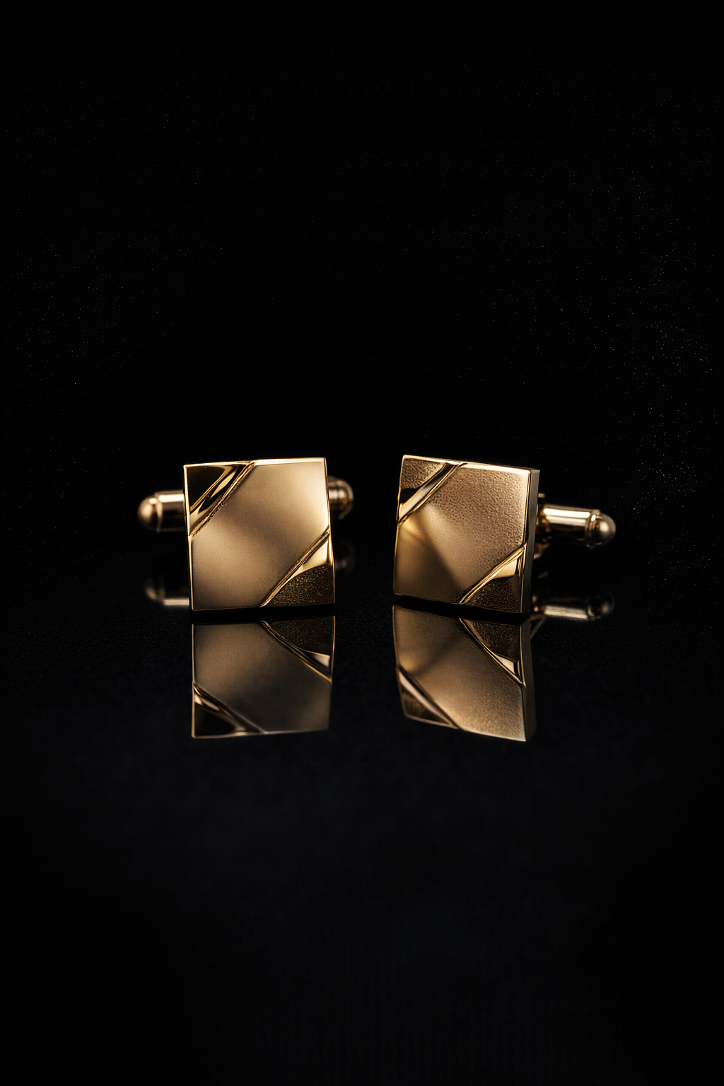 Gold square cufflinks with engraved diagonal detailing on black.