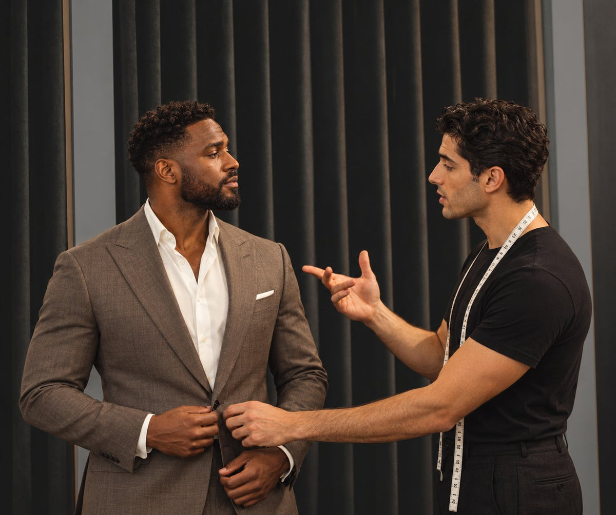 An URBBANA stylist discussing the fit of a jacket with a client