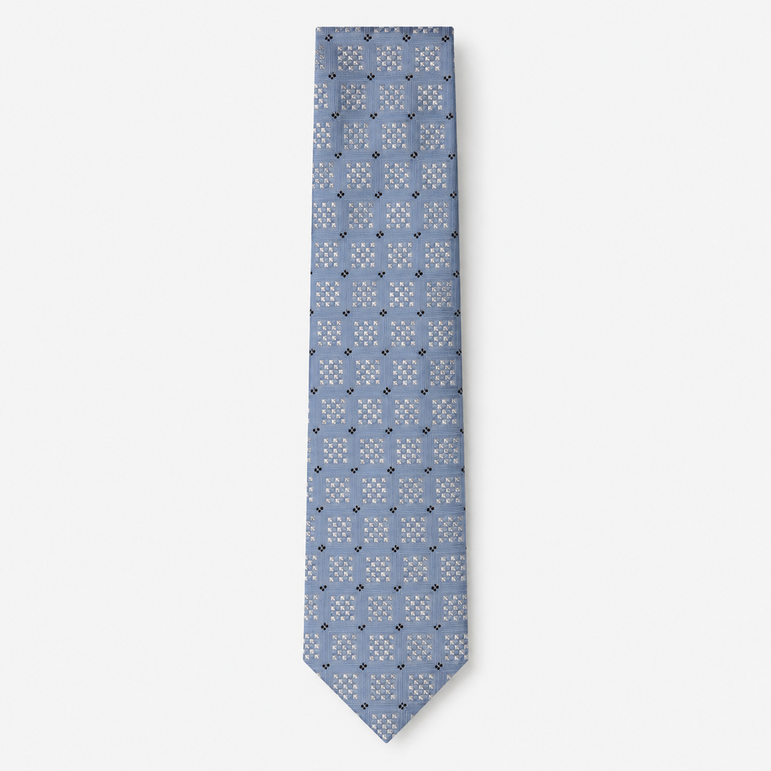The Positano Tie, a light blue silk tie with white geometric checks and navy accents on a light grey background.