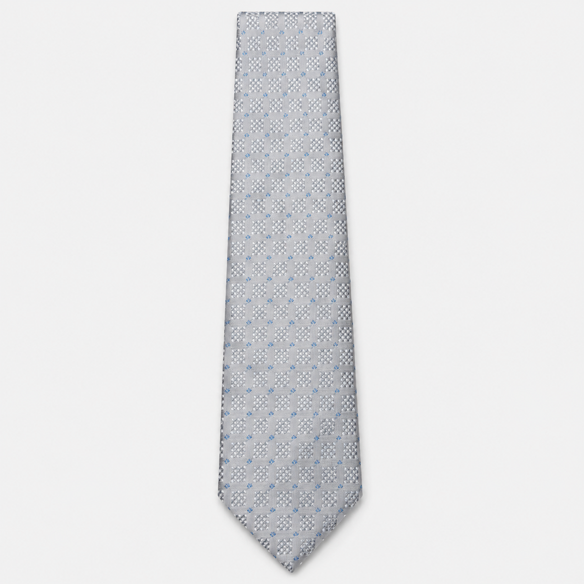 The Terni Tie – silver grey and light blue geometric silk tie on a light grey background