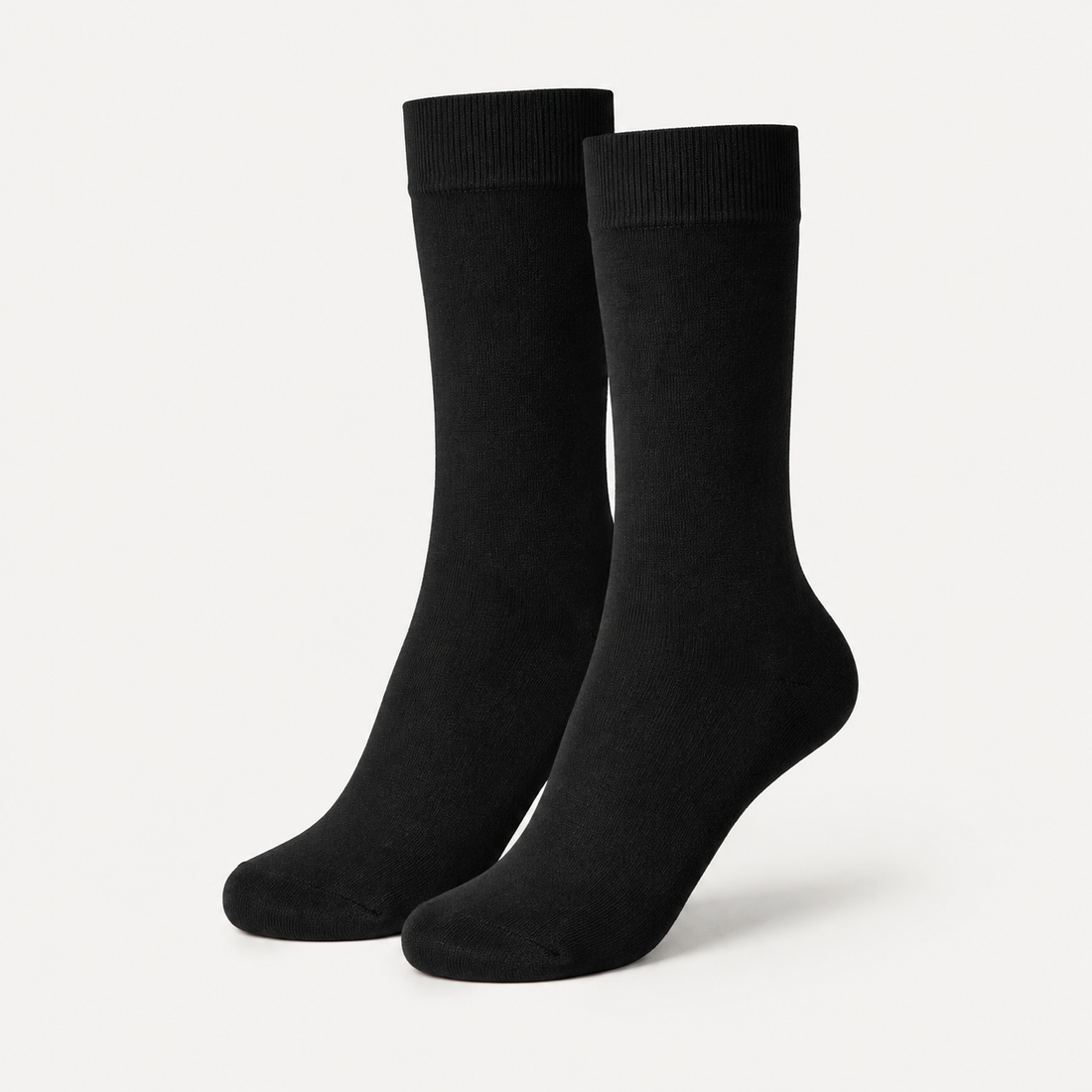 Black dress socks by URBBANA on a light grey studio background