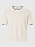 Cream short-sleeve knitted crew-neck shirt with black trim.