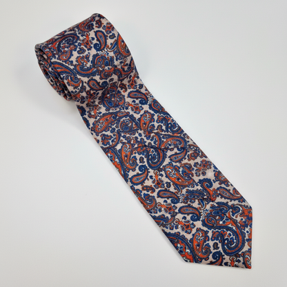 Firenze silk tie with an intricate red, navy and cream paisley pattern.