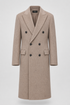 Crème London double-breasted overcoat with peak lapels and flap pockets.