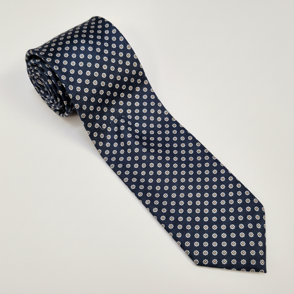 Milano silk tie in navy with a small cream geometric pattern.