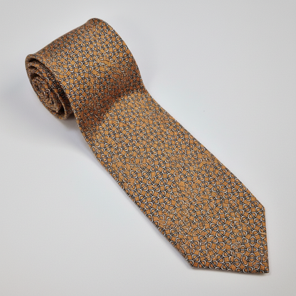 Napoli silk tie with an orange and blue micro-geometric pattern.