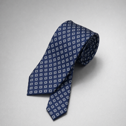 Navy silk necktie with a small light blue diamond pattern.