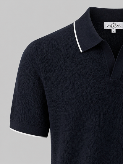 Close-up of a navy knitted polo shirt with white collar trim.
