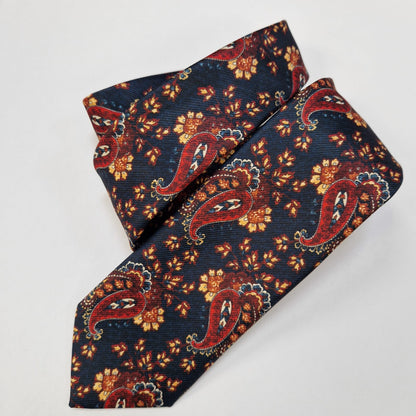 Navy and orange paisley silk tie, loosely folded.