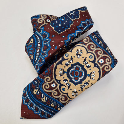 Red, blue and cream medallion paisley silk tie, loosely folded.