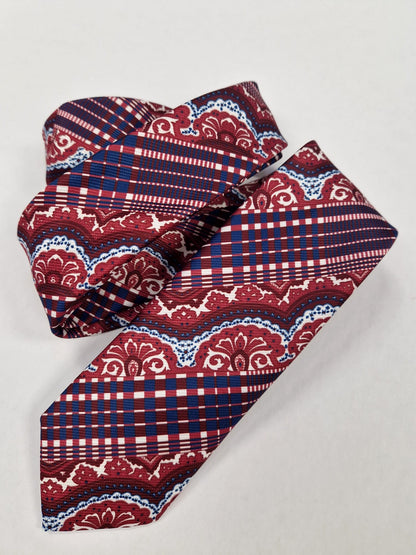 Red and navy paisley plaid silk tie, loosely folded.