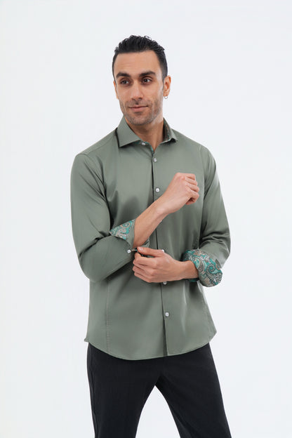 Male model wearing a sage green shirt with patterned turned-back cuffs.