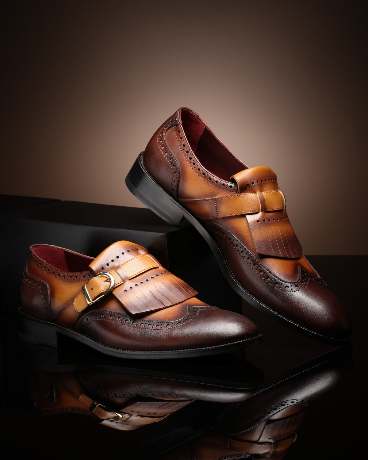 URBBANA tan and brown fringed brogue loafers.